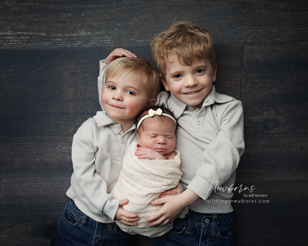 Siblings in neutral earthy tones for newborn photography
